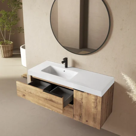 Mueble de baño moderno con lavabo, espejo redondo y cajones de almacenamiento.